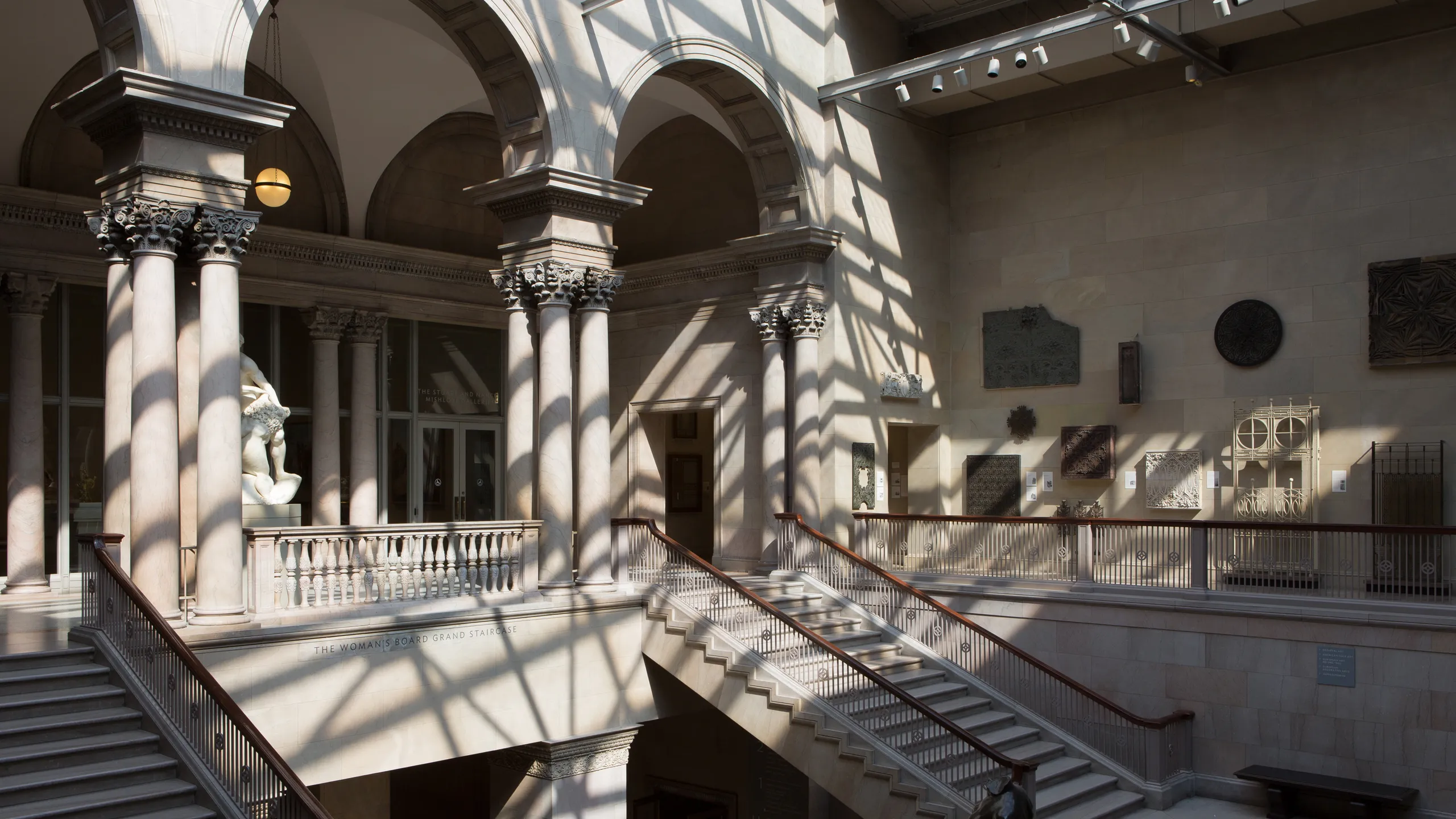 A quiet gallery inside the Art Institute of Chicago with visitors viewing large framed paintings under soft museum lighting
